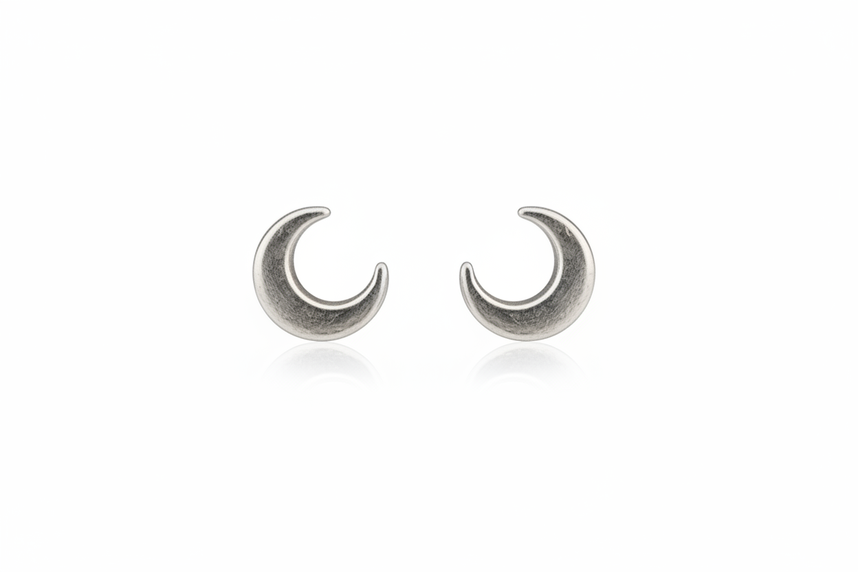 Pair of silver crescent moon earrings on a white background