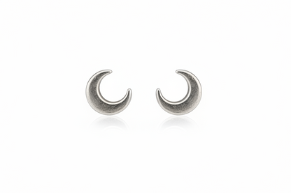 Pair of silver crescent moon earrings on a white background