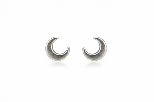 Pair of silver crescent moon earrings on a white background