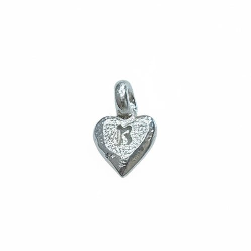 Silver heart-shaped pendant with engraved design on a white background