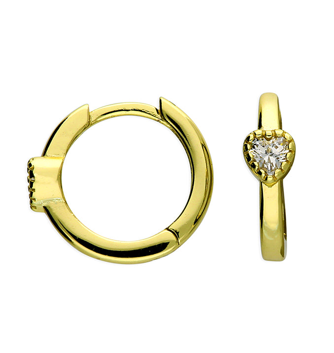 Gold hoop earring and heart-shaped diamond earring on a white background