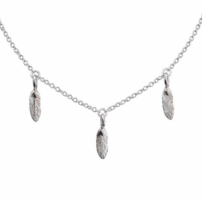 Silver necklace with feather pendants on a white background
