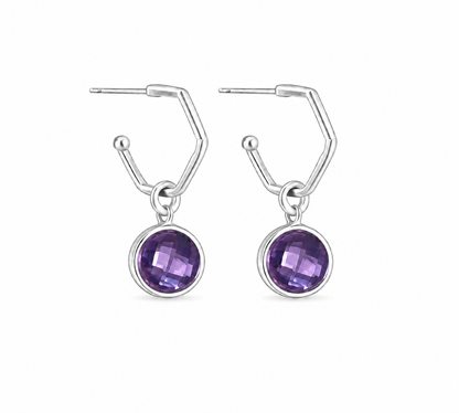 A pair of silver drop earrings with a amethyst purple gemstone in a bezel setting, shown on a plain white background.