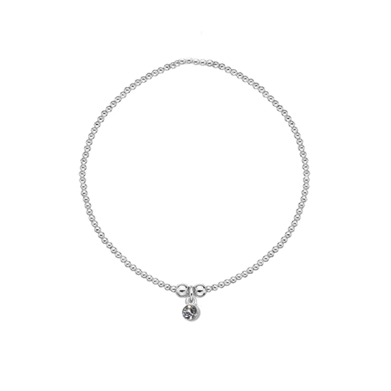 Silver bracelet with a small charm on a white background