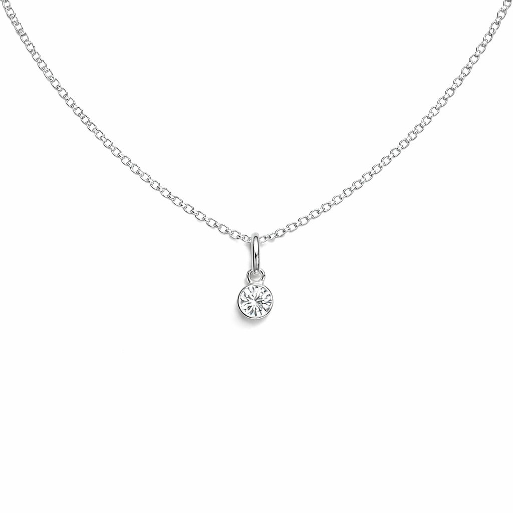 Silver necklace with a small round birthstone pendant on a white background