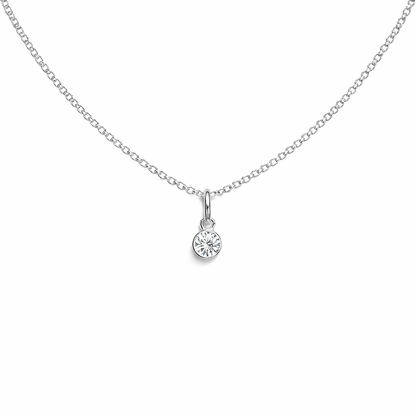 Silver necklace with a small round birthstone pendant on a white background