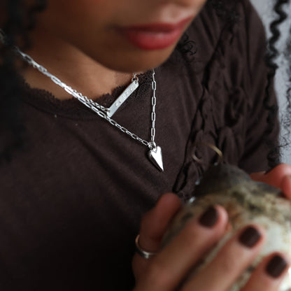 Woman holding a textured object with blurred lights in the background