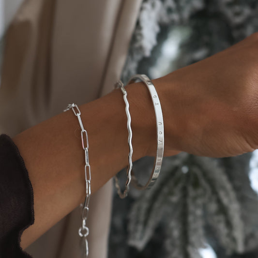 Hand holding a textured ornament with a decorative background