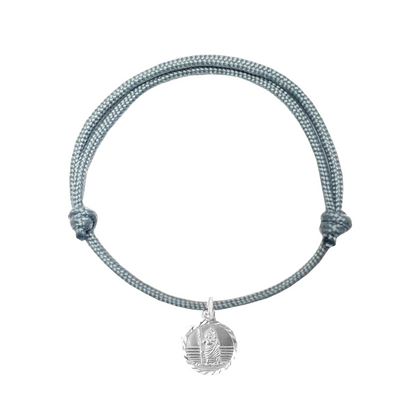 Gray braided bracelet with a silver pendant on a white background