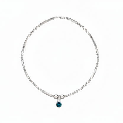 Silver bracelet with a blue gemstone on a white background