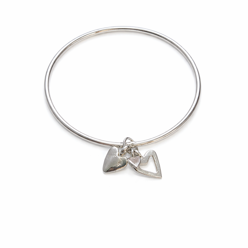 Sterling silver Endless Love Bangle with a solid heart charm and an open heart charm on a white background