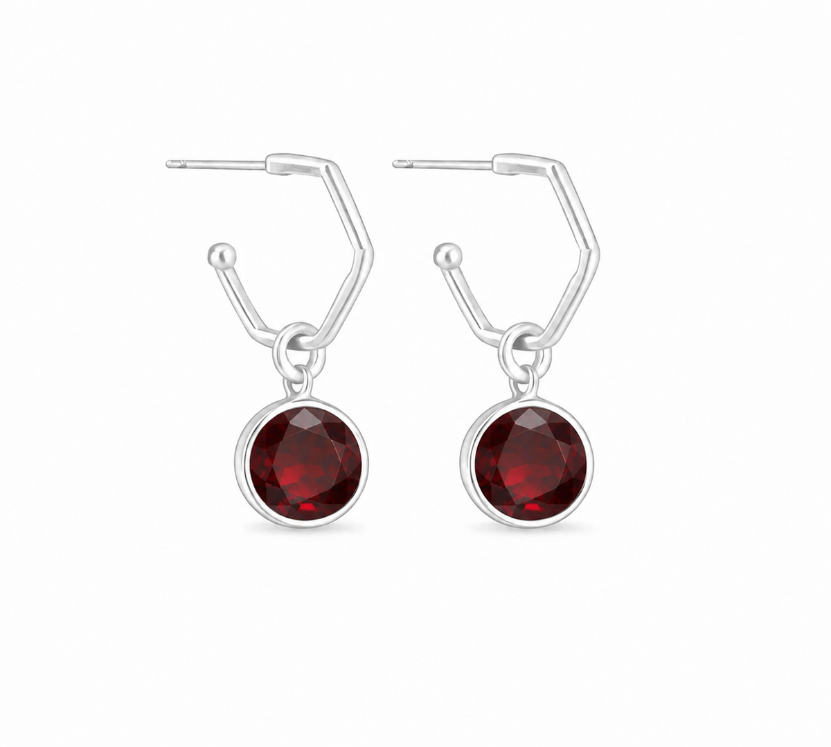 a  pair of sterling silver hoops with a garnet gemstone
