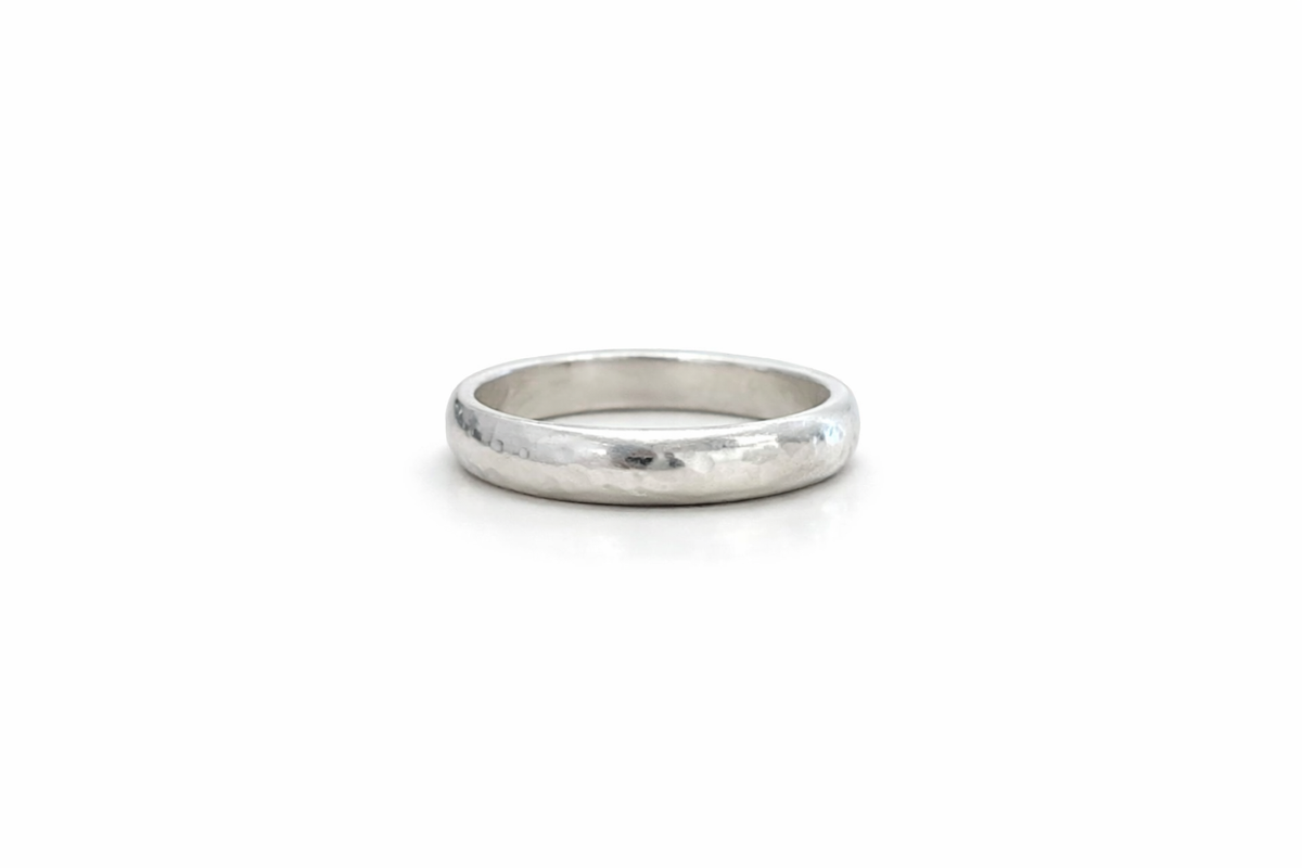 Sterling silver Hammered D Band ring with a rounded profile and textured hammered finish on a white background