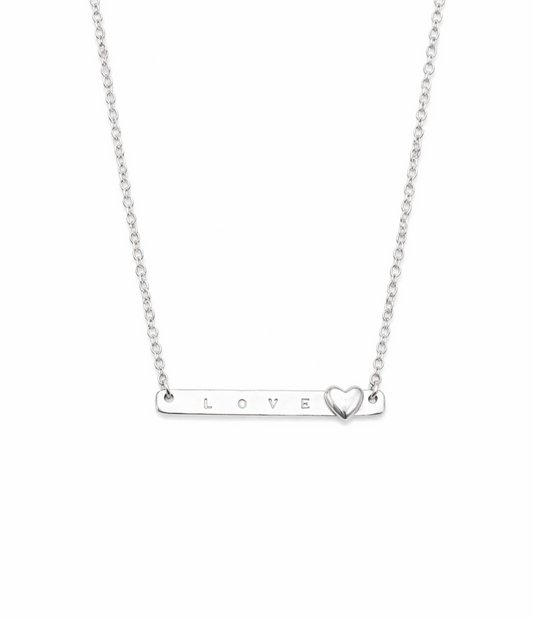 Silver necklace with 'LOVE' bar and heart pendant on a white background
