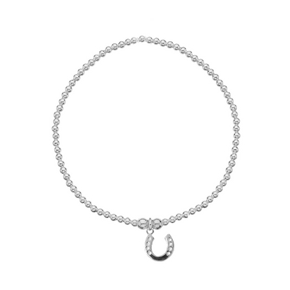 Silver bracelet with a horseshoe charm on a white background