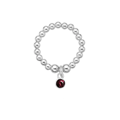 Silver beaded ring with a red gemstone charm on a white background