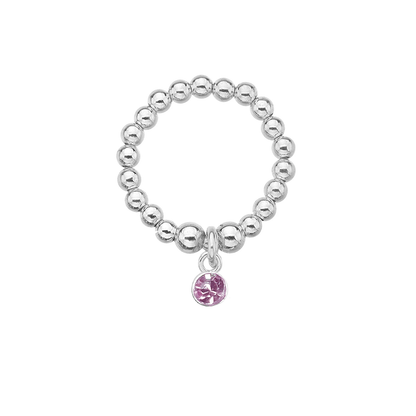 Silver beaded ring with a pink charm on a white background