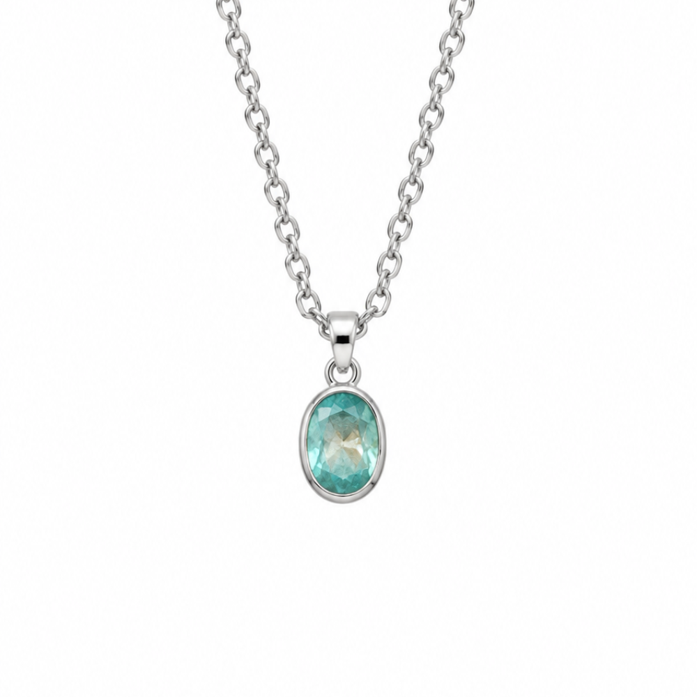 A silver belcher chain necklace with an oval bezel setting holding a light green kyanite stone, shown against a plain white background.
