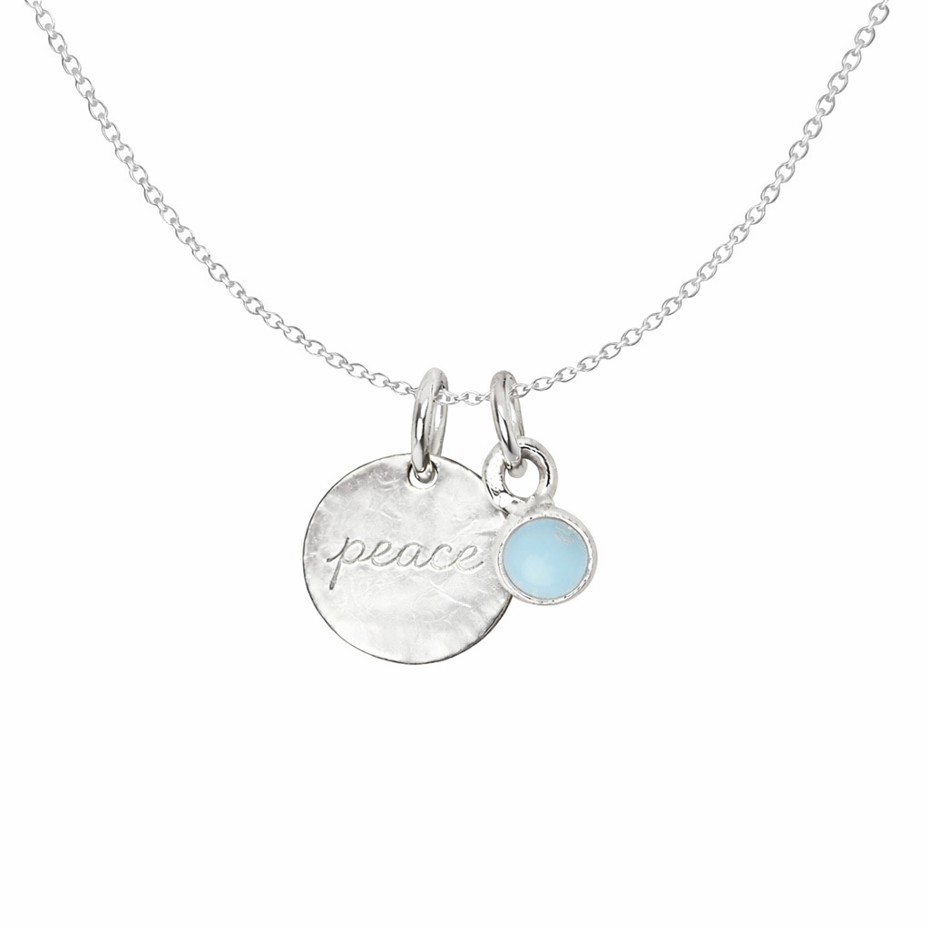Necklace with 'peace' pendant and larimar gemstone on a white background