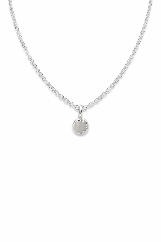 Sterling silver Mini Lava Necklace with a small round pendant and textured edge on a white background
