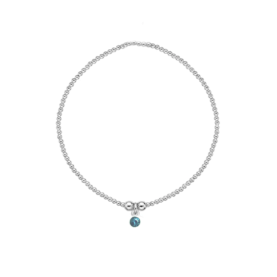 Silver bracelet with a blue gemstone on a white background