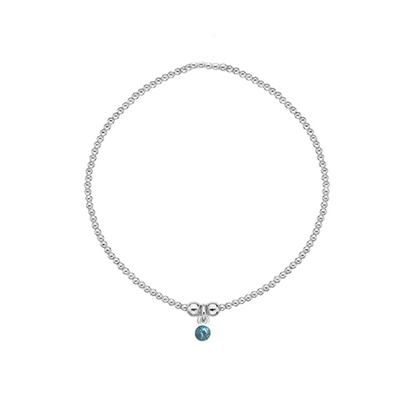 Silver bracelet with a blue gemstone on a white background