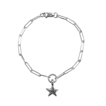 Mini star charm on a trace bracelet on a white background 