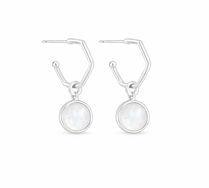 Pair of silver hoop earrings with round moonstone charms on a white background