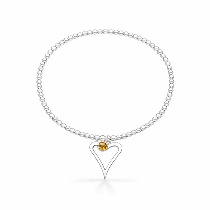 Silver birthstone bracelet with a heart-shaped charm on a white background