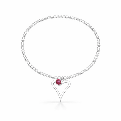 Silver bracelet with a heart-shaped charm and pink gemstone on a white background