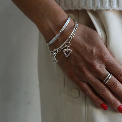 sterling silver Open Heart Trace Bracelet worn on a wrist, with a heart charm.
