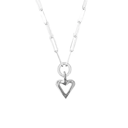 A sterling silver necklace with a heart-shaped pendant on a chain trace design, handcrafted.