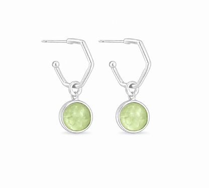 a pair of silver hoops featuring a perdiot hoop charms on a white background