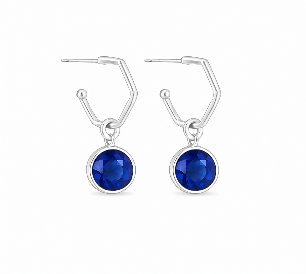 A pair of silver hoop earrings featuring sapphie charms shown on a plain white background.