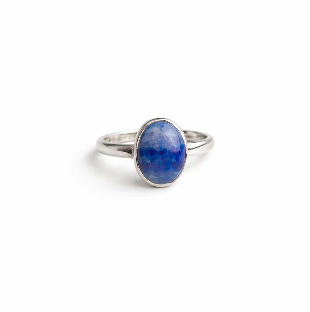 Silver ring with a blue stone on a white background