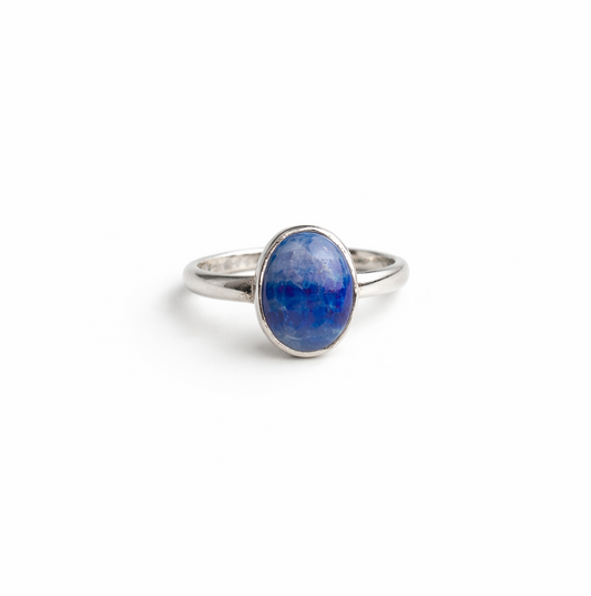 Silver ring with a blue stone on a white background