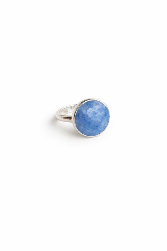 Silver ring with a blue gemstone on a white background