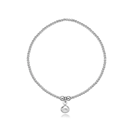 Silver bracelet with a small seashell charm on a white background