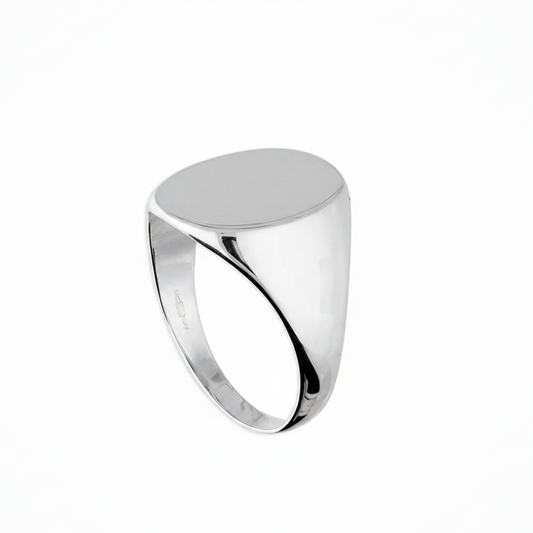 A polished silver signet ring with a smooth, flat oval face, shown on a clean white background.