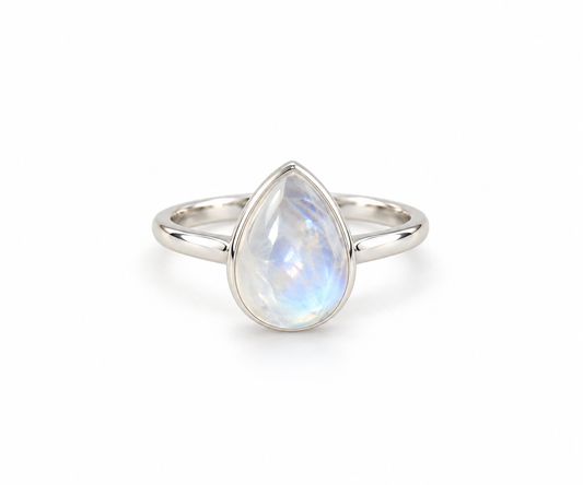 A silver ring featuring a teardrop-shaped iridescent moonstone gemstone, shown on a clean white background.