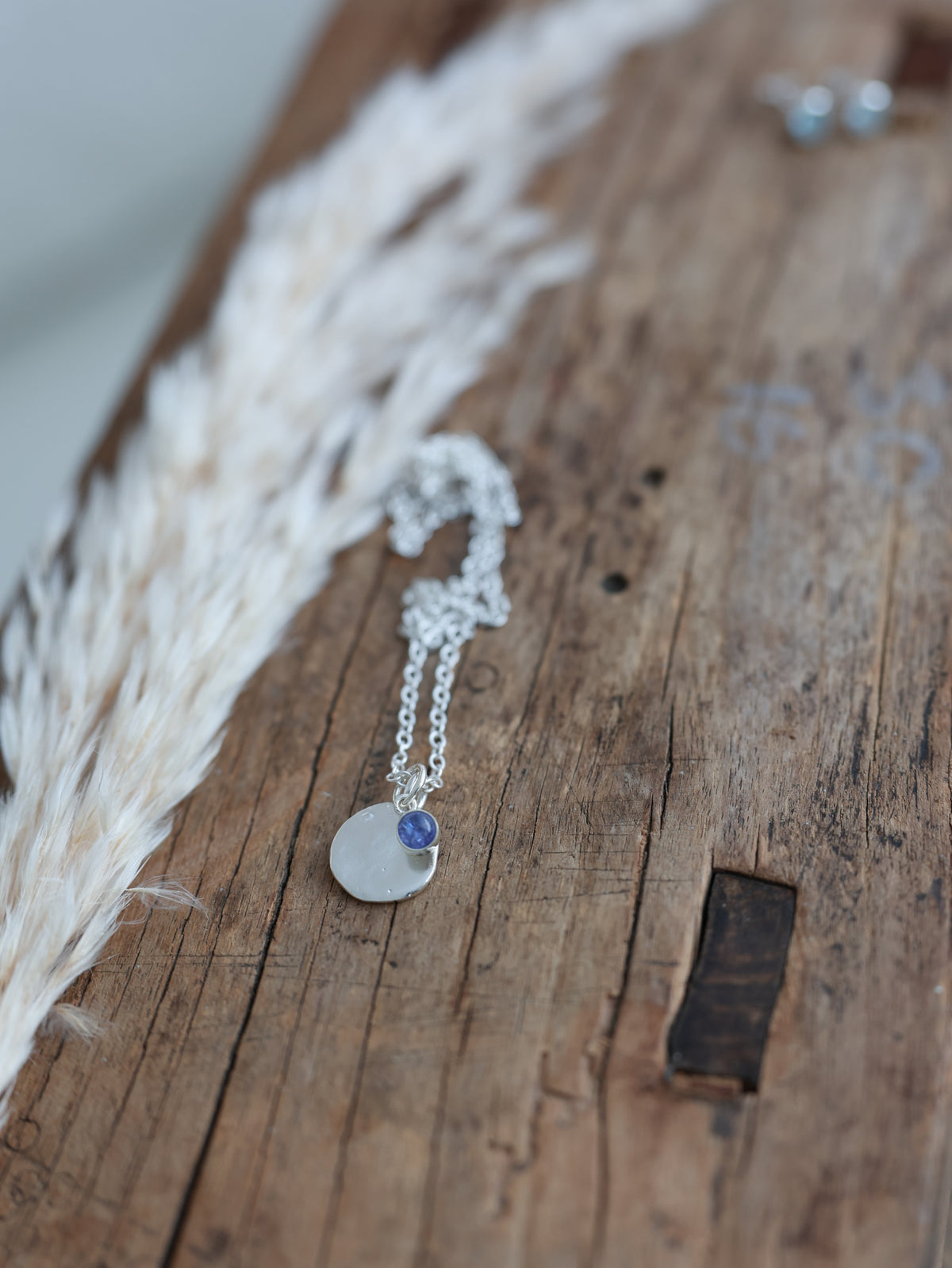 Sterling silver Tanzanite Talisman Necklace with a textured round disc and purple gemstone 