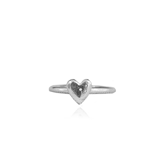 sterling silver ring with a heart-shaped design on the top, handcrafted and displayed against a white background.