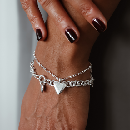 True Love sterling silver heart bracelet worn on a wrist.