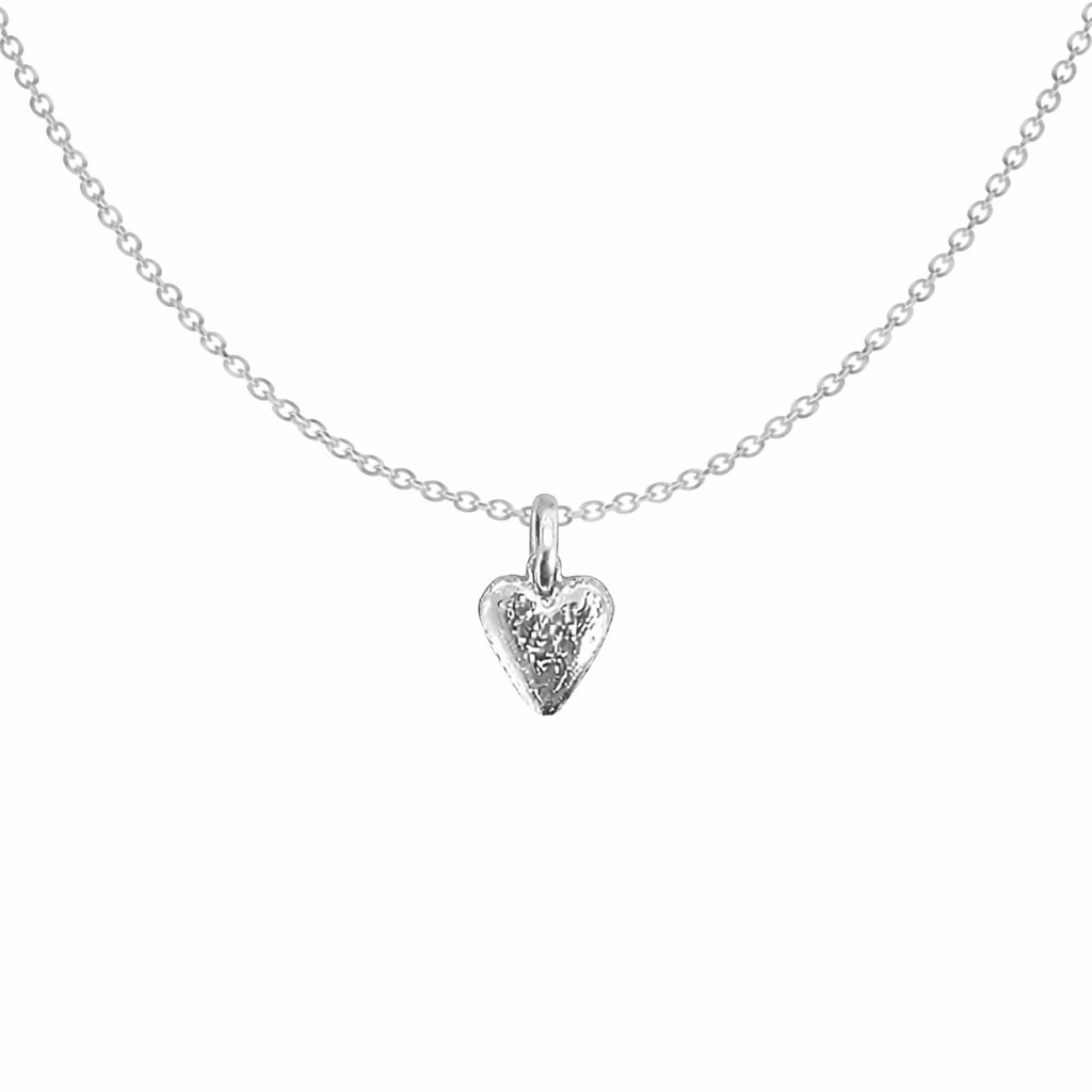 Silver heart-shaped pendant necklace on a white background